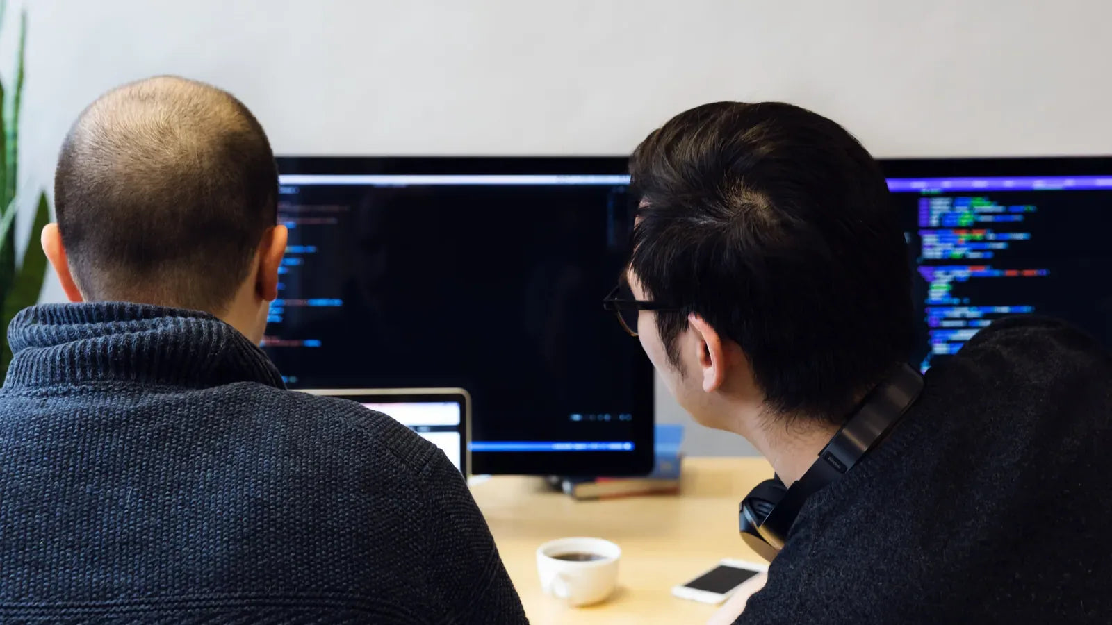 Programmers Reviewing Code On Computer.