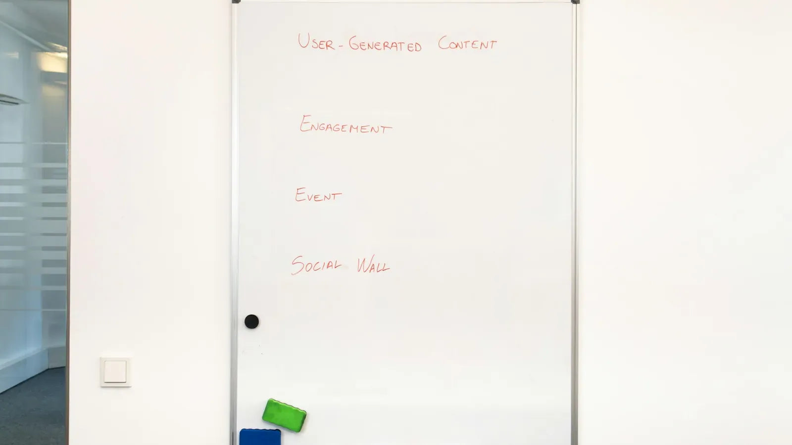 A white board with writing on it in a room.