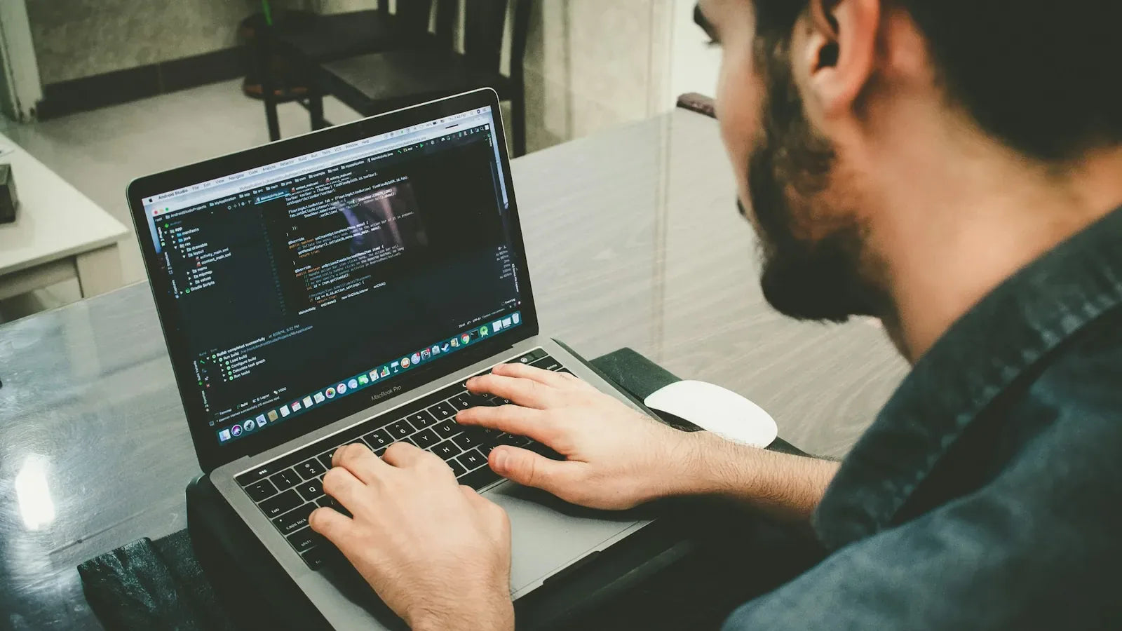 Man programming using laptop.