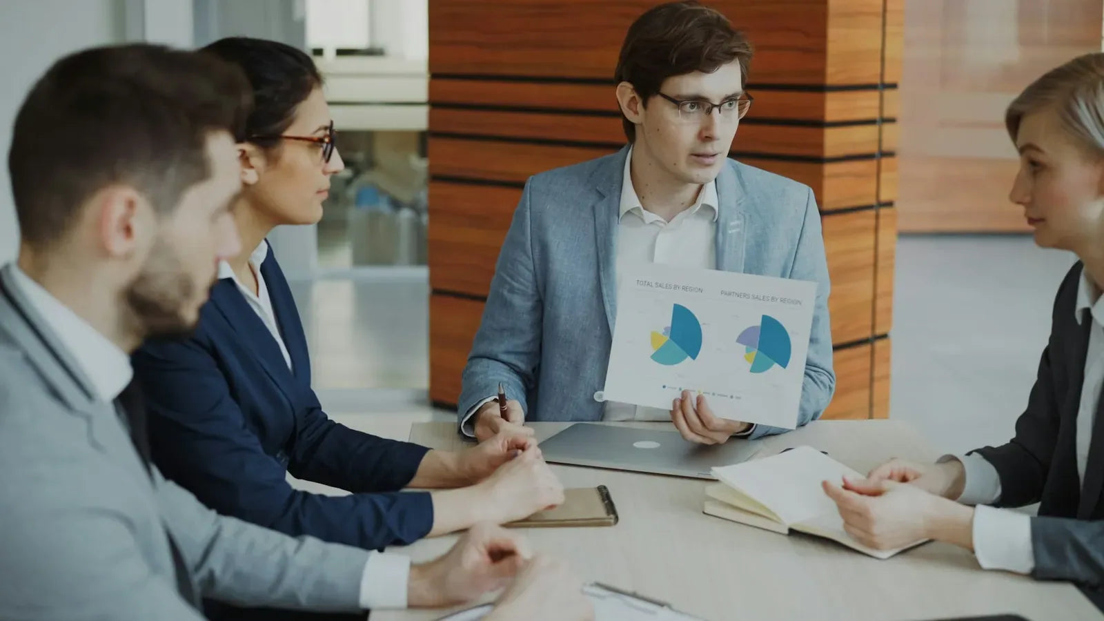 Team discussing charts during a business meeting.